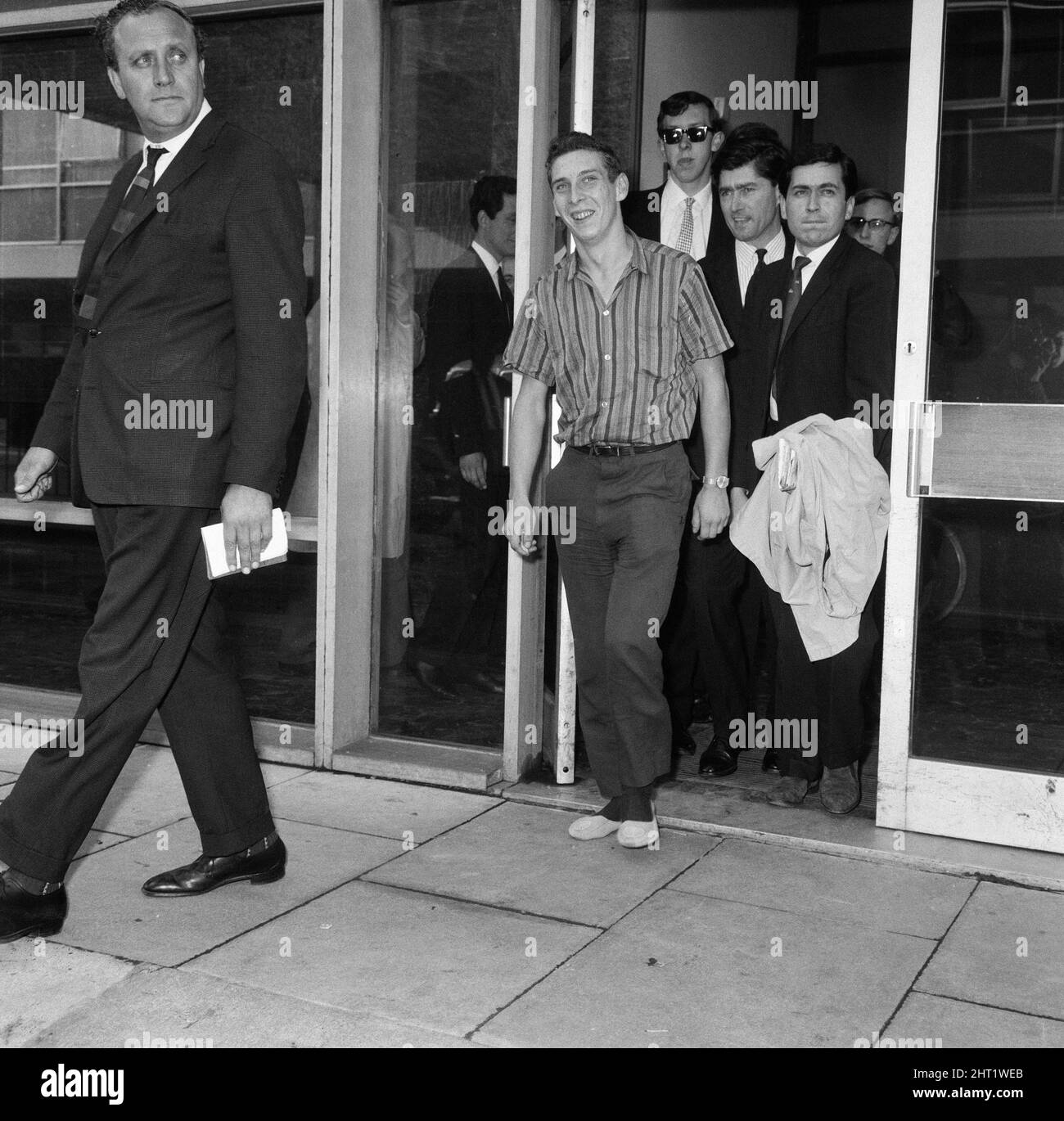 Stiff and limping, home-sick Welshman Brian Robson, 19, who tried to send himself back to Cardiff from Australia arrived at London Airport this morning stiff and limping after his 96 hours in a crate. He had been given a seat in a Pan American jet airliner from Los Angeles. 18th May 1965. Stock Photo