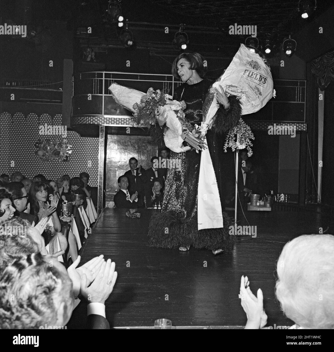 Shirley Bassey receives bouquets of flowers on stage. 13th September 1965. Stock Photo