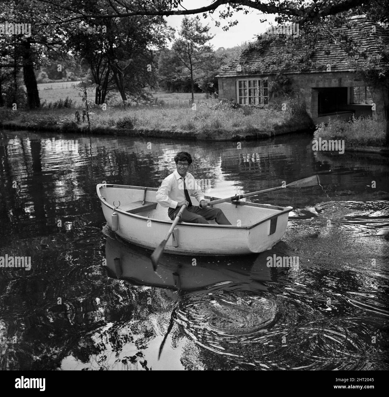 Freddie and the Dreamers pop group give a show at Lord Bath's ancestral home in Longleat, Wiltshire Lead singer Freddie rowing a boat on the river August 1965 Stock Photo