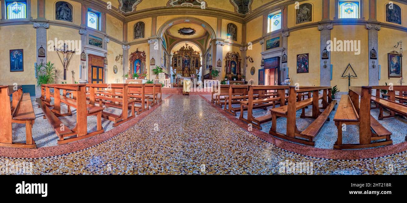 Parrocchia Dei Santi Pietro E Paolo Panoramic interior view of benches and altar of the Valmareno church