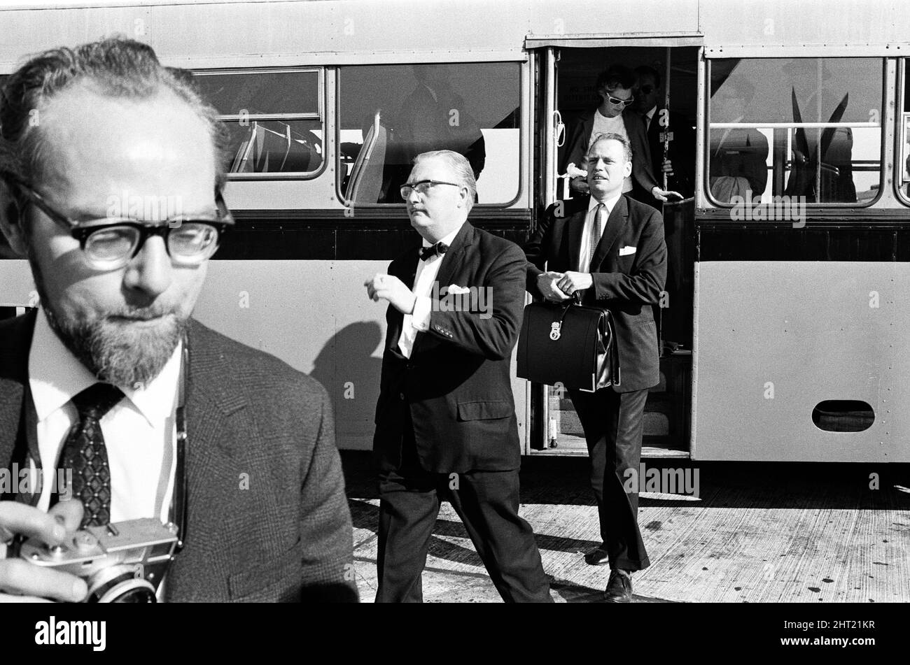 Detective Chief inspector John Hensley (wearing glasses, not the man holding camera) and Detective Inspector Jack Slipper leave London airport for Glasgow to bring John Duddy back to London. John Duddy was wanted for questioning in connection with the shooting of three London policemen. He later went on to be convicted of murder and possession of firearms and sentenced to life imprisonment. 18th August 1966. Stock Photo