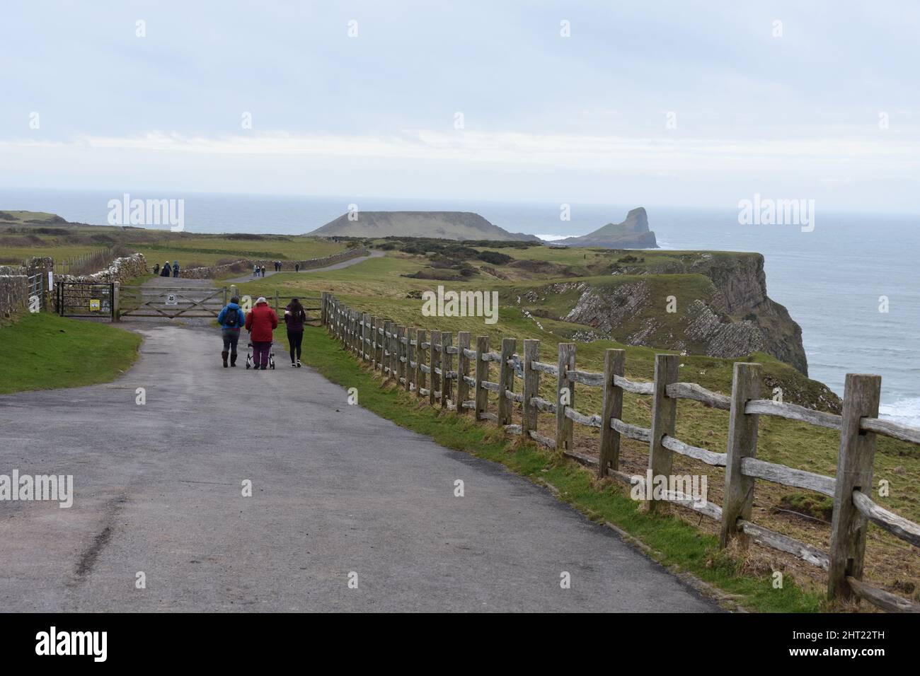 People walking along the Rhossili headland path towards Worms Head, Rhossili, Gower, Wales Stock Photo