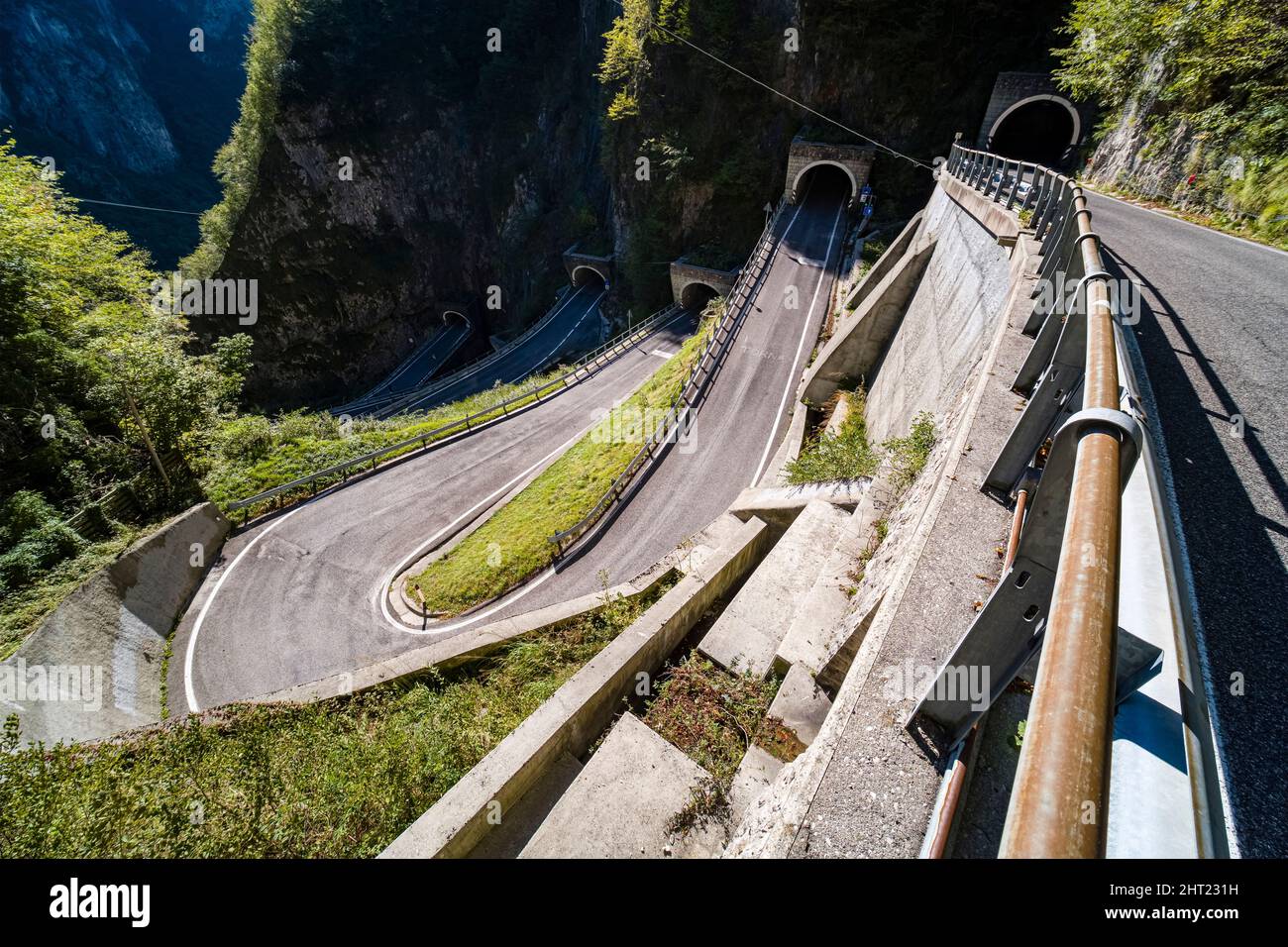 Aerial view on the hairpin bends, walls and tunnels of the San Boldo Pass. Stock Photo