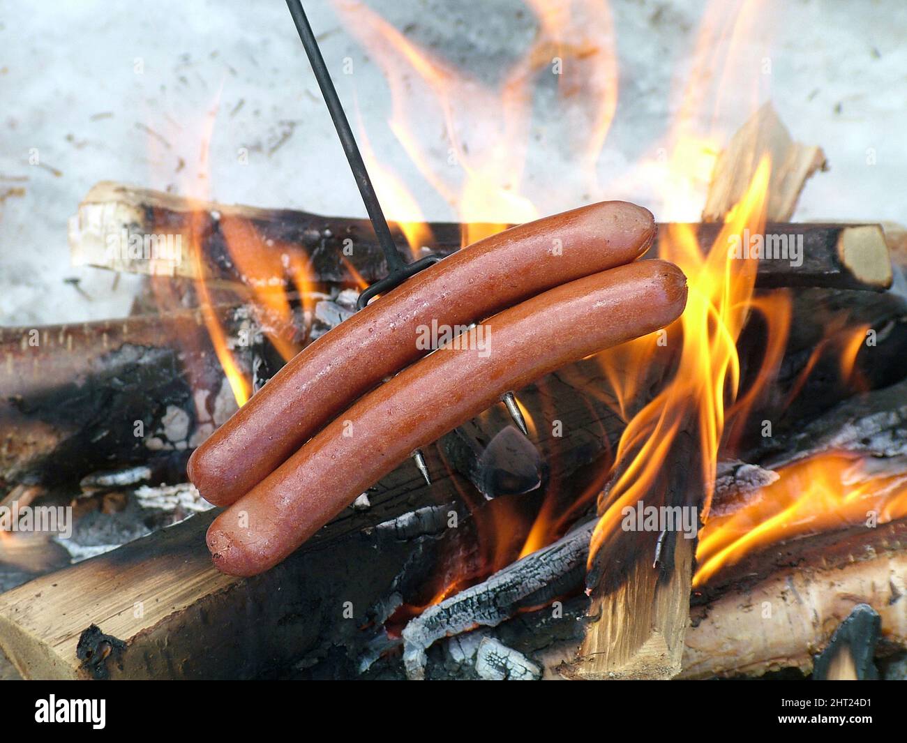 Sausages are grilled over an open fire Stock Photo