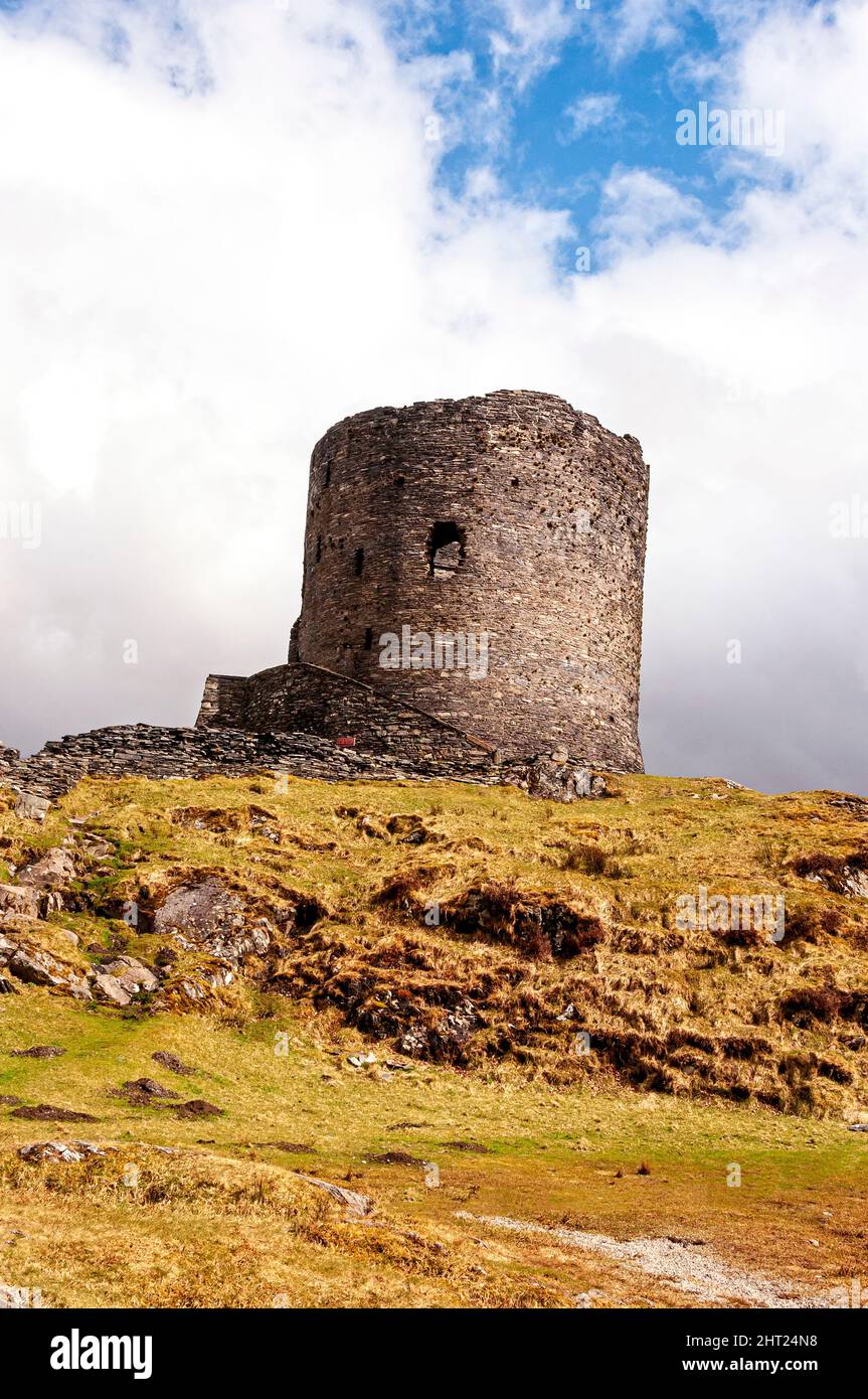 The ruins of 13th century Dolbadarn Castle stone keep, a Welsh round tower, built by Llewelyn the Great to control the Llanberis mountain pass Stock Photo