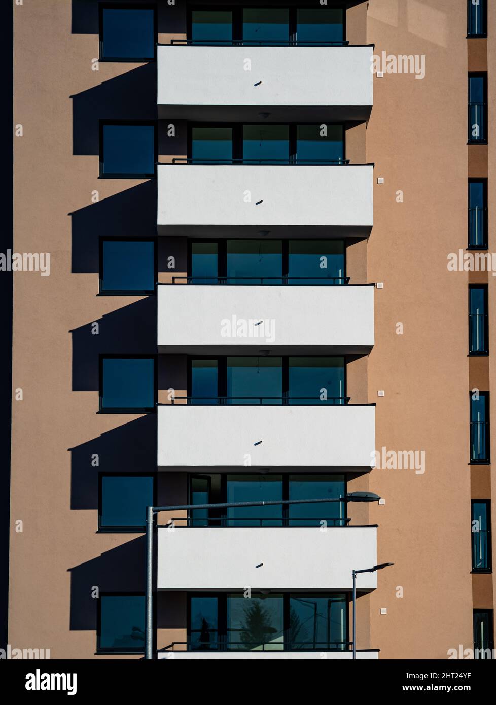 Vertical shot of the facade of a modern building with balconies on a ...