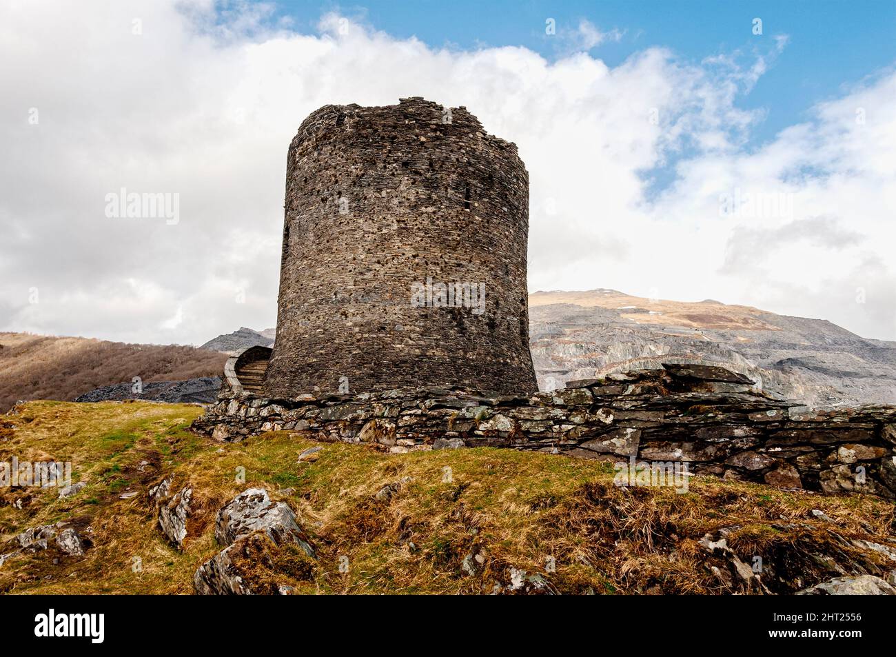 The ruins of 13th century Dolbadarn Castle stone keep, a Welsh round tower, built by Llewelyn the Great to control the Llanberis mountain pass Stock Photo