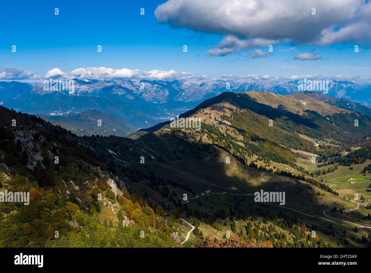 View from the top of Monte Grappa towards the north, Dolomites in the far distance. Stock Photo