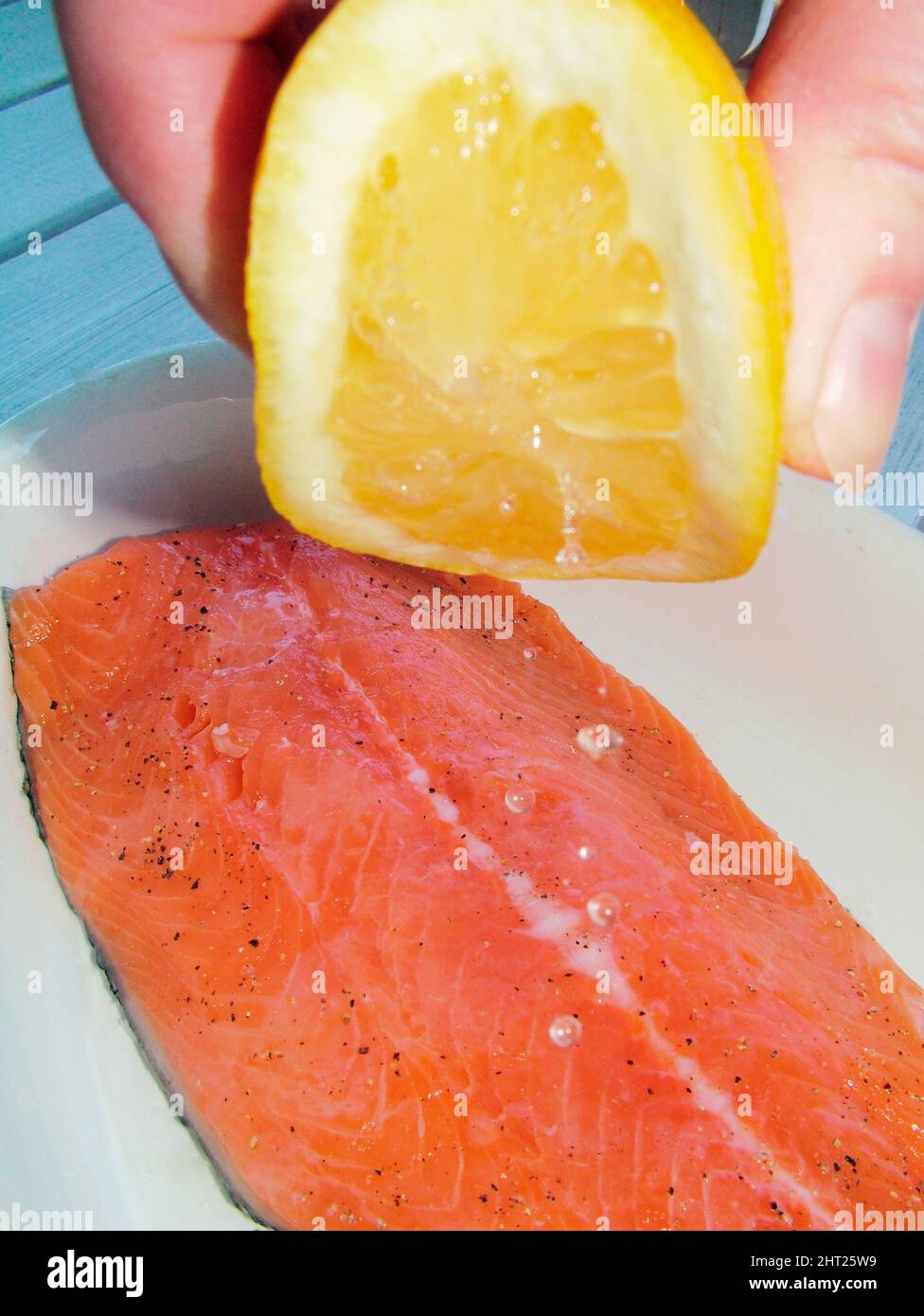 Lemon juice on salmon fillet Stock Photo Alamy