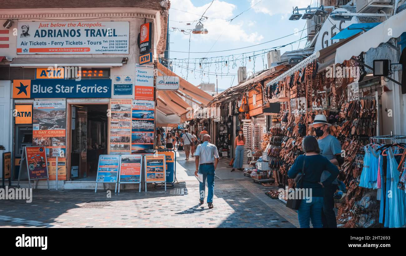 Consumers walk on main commercial street of Athens during the summer