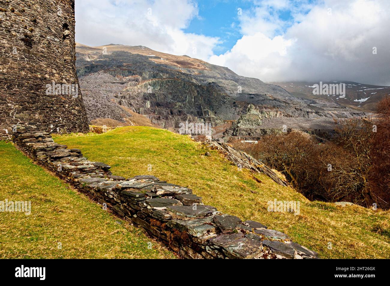 The ruins of 13th century Dolbadarn Castle stone keep, a Welsh round tower, built by Llewelyn the Great to control the Llanberis mountain pass Stock Photo