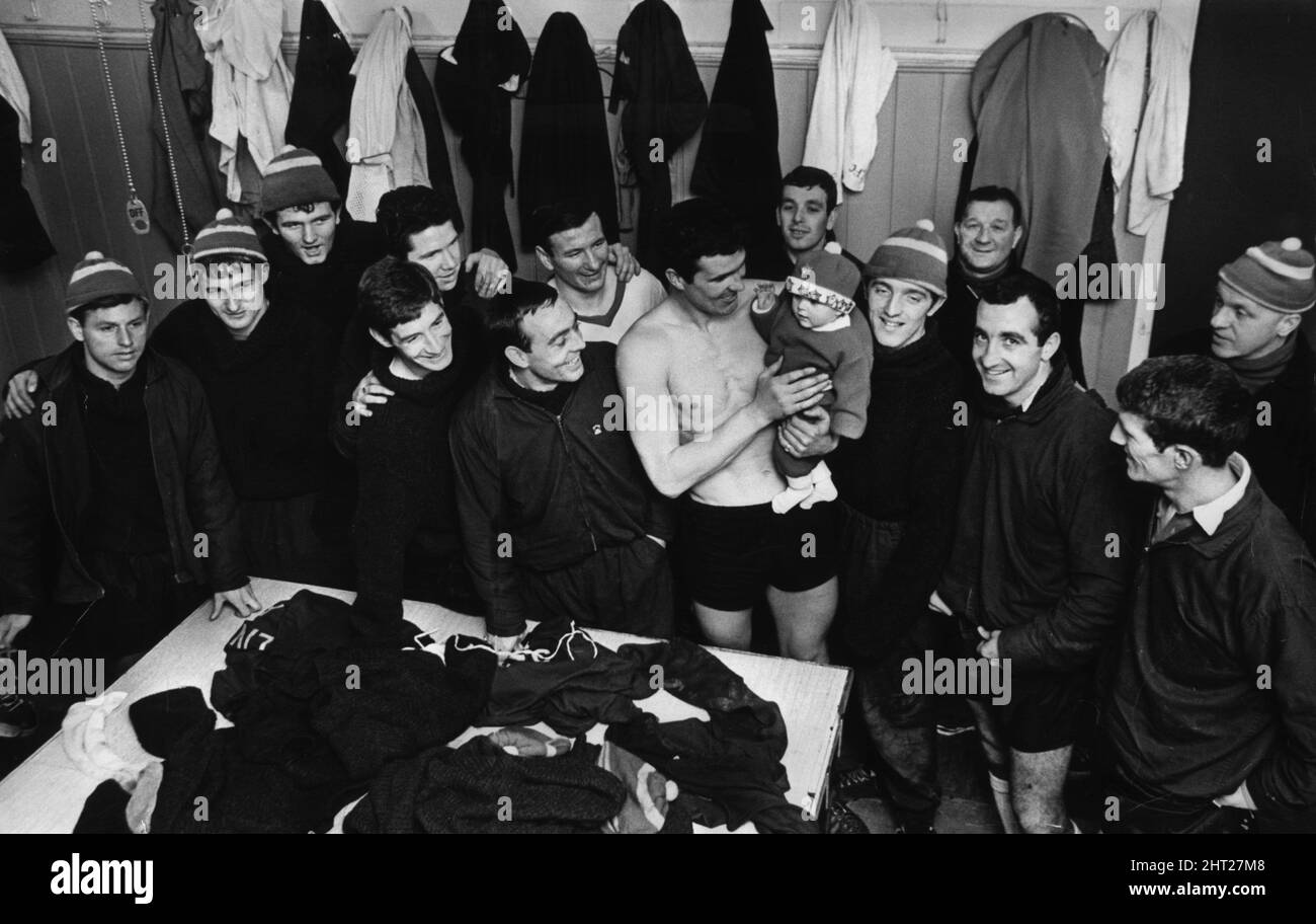 Baby Paula O'Sullivan meets the men she will never be able to forget - Liverpool football team. April 1966.   Paula is being held by Ron Yeats    Also pictured    Ian St John  Bill Shankly  Bob Paisley    Tiny Paula was named after the whole of Liverpool's 1965 FA Cup winning side, plus manager & 2 assistants, by her football crazy father Peter O'Sullivan (34, bricklayer).    The baby's full name is Paula St John Lawrence Lawler, Byrne Strong Yeats Stevenson Callaghan Hunt Milne Smith Thomspon Shankly Bennett Paisley O'Sullivan. Stock Photo