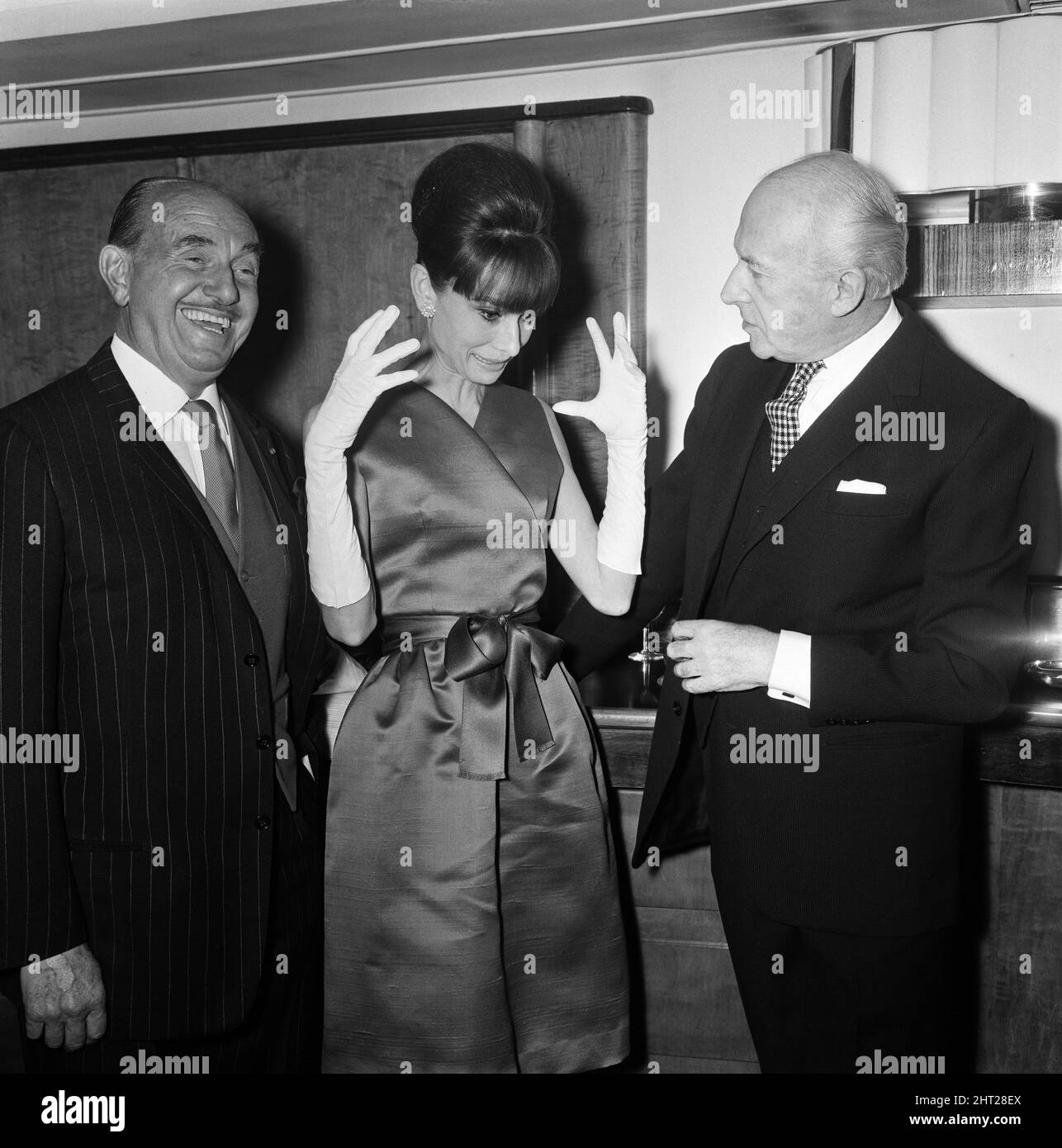 Actress Audrey Hepburn pictured with Jack L Warner (left) and Cecil Beaton at a press reception at the Savoy Hotel in London, held for some of the stars of the film 'My Fair Lady'. 19th January 1965. Stock Photo