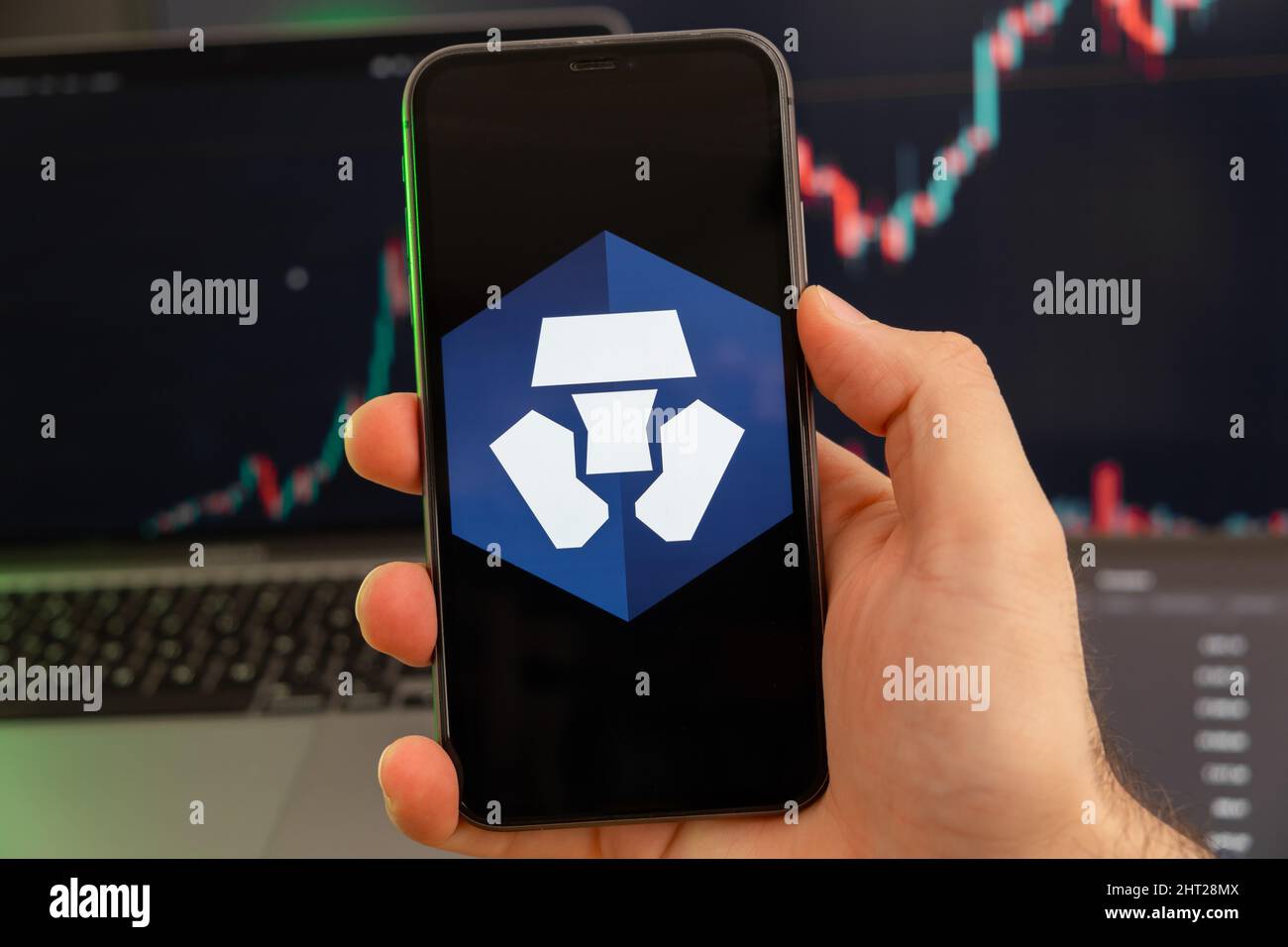 Crypto.com Coin CRO app of cryptocurrency stock market analysis on the  screen of mobile phone in man hands and growing charts trading data on the  background, February 2022, San Francisco, USA Stock