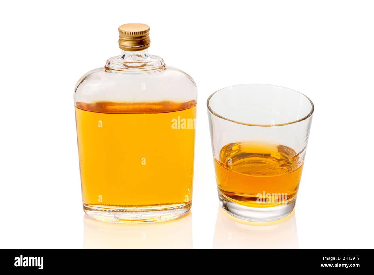 Glass whiskey hip flask, or whisky or bourbon, near a glass of whiskey  isolated on white, clipping path Stock Photo