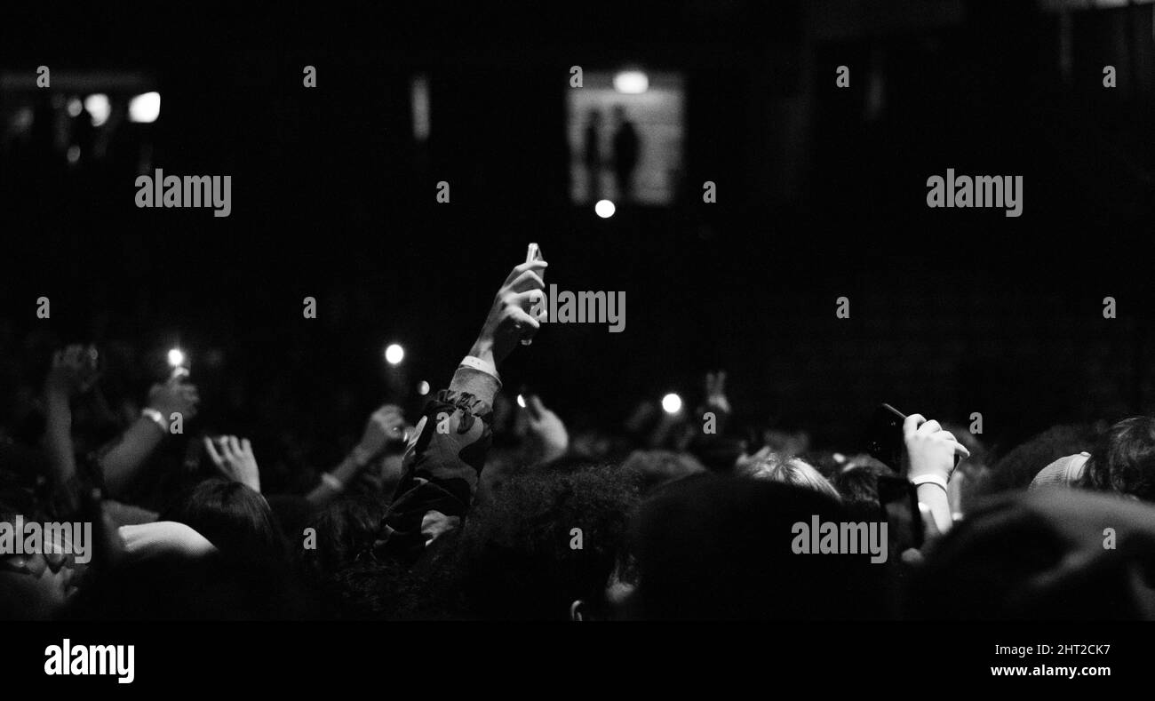 Hand holding phones crowd Black and White Stock Photos & Images - Alamy