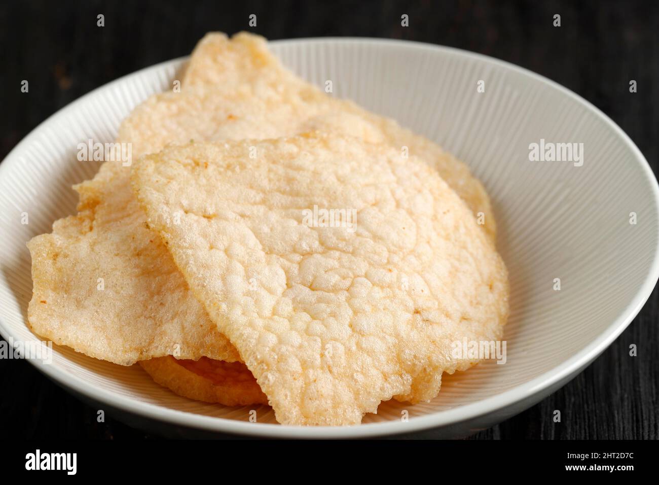 Close Up Kerupuk Udang or Shrimp Crackers or Prawn Crackers. On Wooden Table Stock Photo