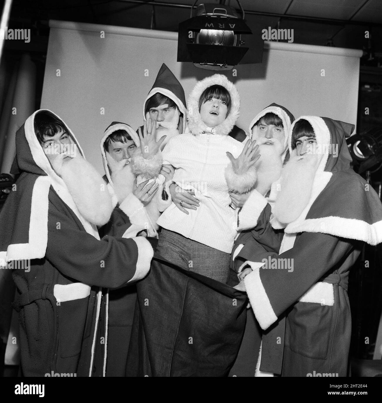 Christmas preparations for Ready Steady Go! at Rediffusion  - British rock group The Animals with television presenter Cathy McGowan dressed in Father Christmas outfits.1st December 1965. Stock Photo