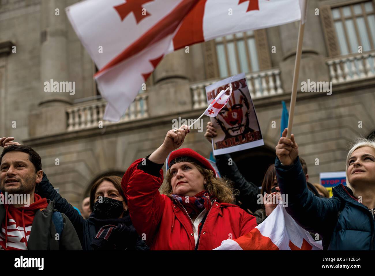 Barcelona, Spain. 26th Feb, 2022. The Georgian national flag is seen among pro-Ukrainian protestors during a protest demanding actions to stop the war as Russian forces close in on Kyiv Credit: Matthias Oesterle/Alamy Live News Stock Photo