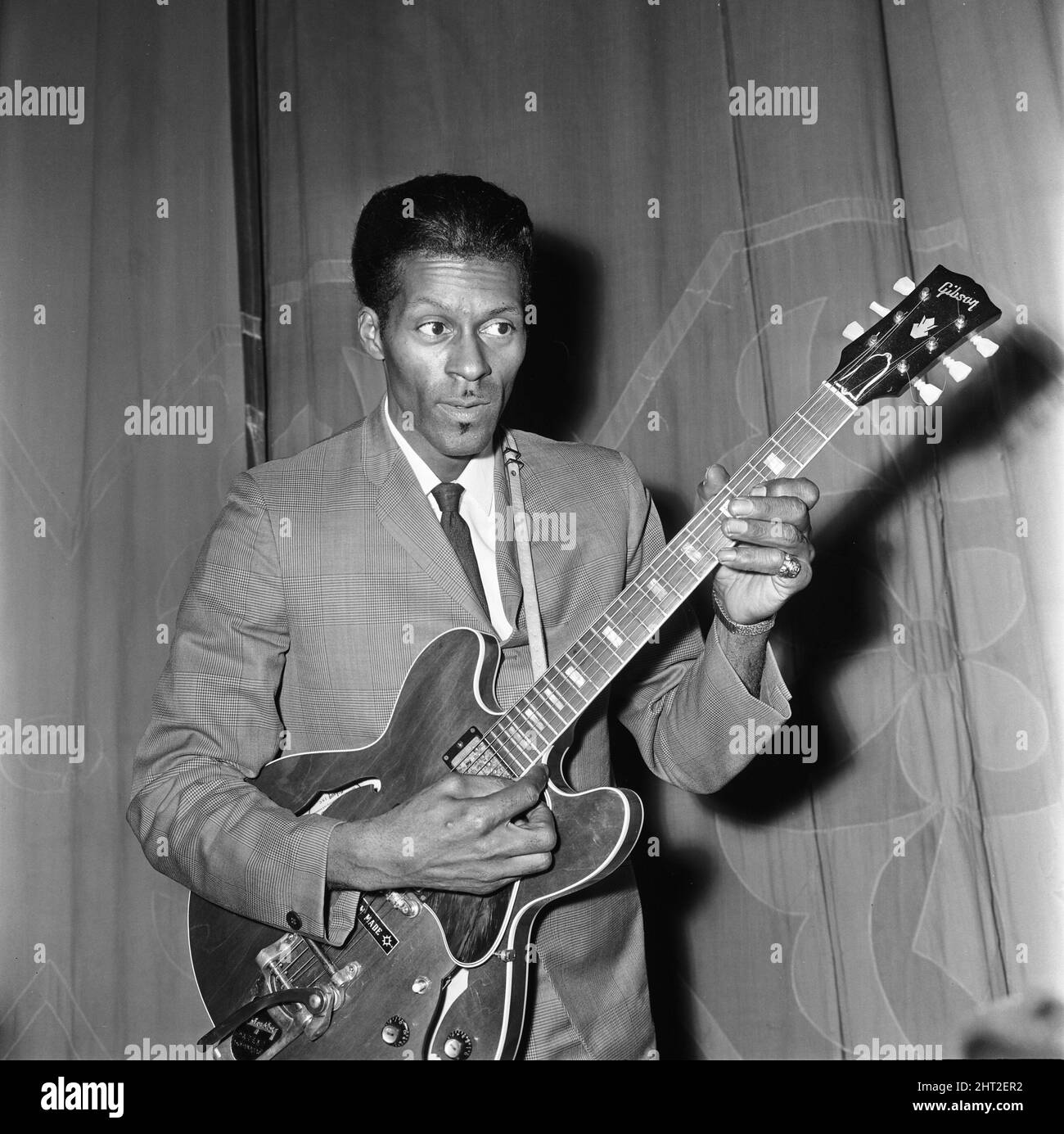 American rock and roll singer and musician Chuck Berry tunes up his