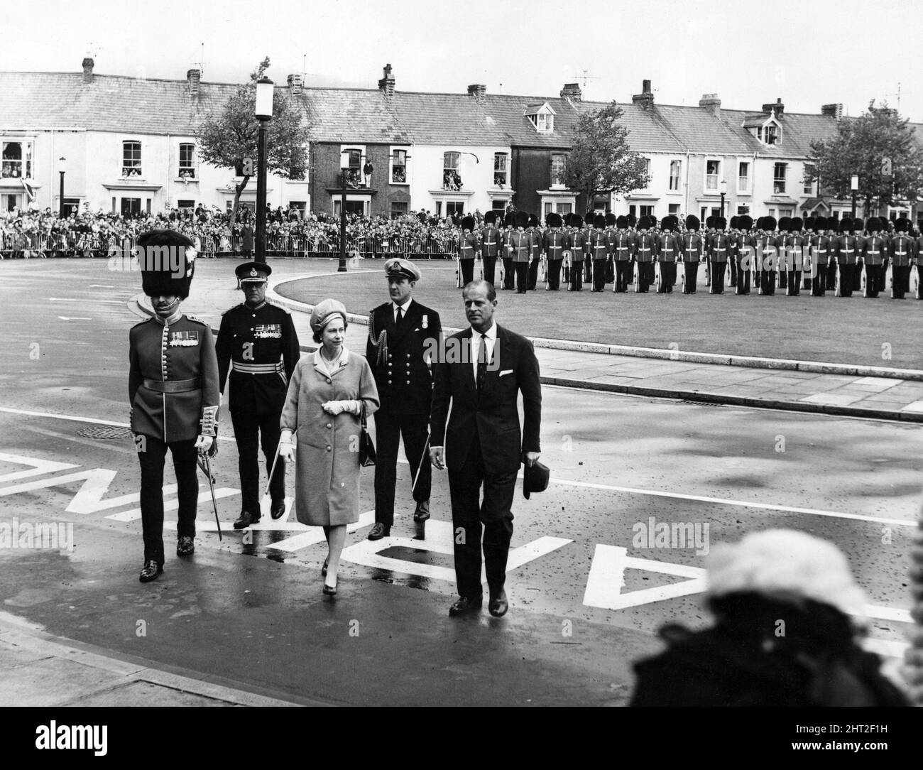 Queen Elizabeth II and Prince Philip, Duke of Edinburgh walk back to the Guildhall, Swansea, after the Queen had inspected the Guard of Honour mounted by the First Battalion The Welsh Guards. 26th June 1965. Stock Photo