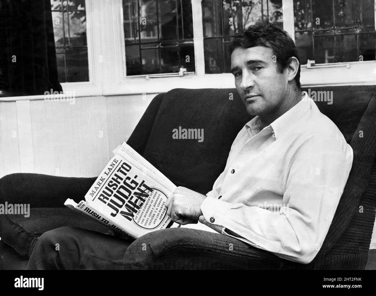 Manchester City assistant manager Malcolm Allison pictured at home reading his book 'Rush To Judgement' after Sunday lunch. Allison is alleged to have been reported to the FA by two referees for misconduct. 16th October 1966. Stock Photo