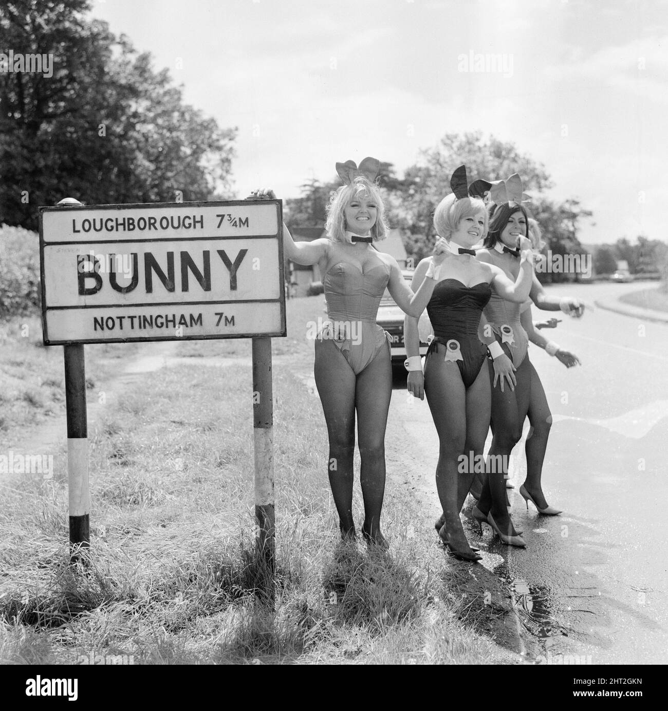 Bunny Girls from the Playboy Club in London visit Bunny, a village and civil parish in the Rushcliffe borough of Nottinghamshire, England, 4th August 1966. Our Picture Shows ... Bunnies looking to hitch-hike by thumbing a lift. Stock Photo