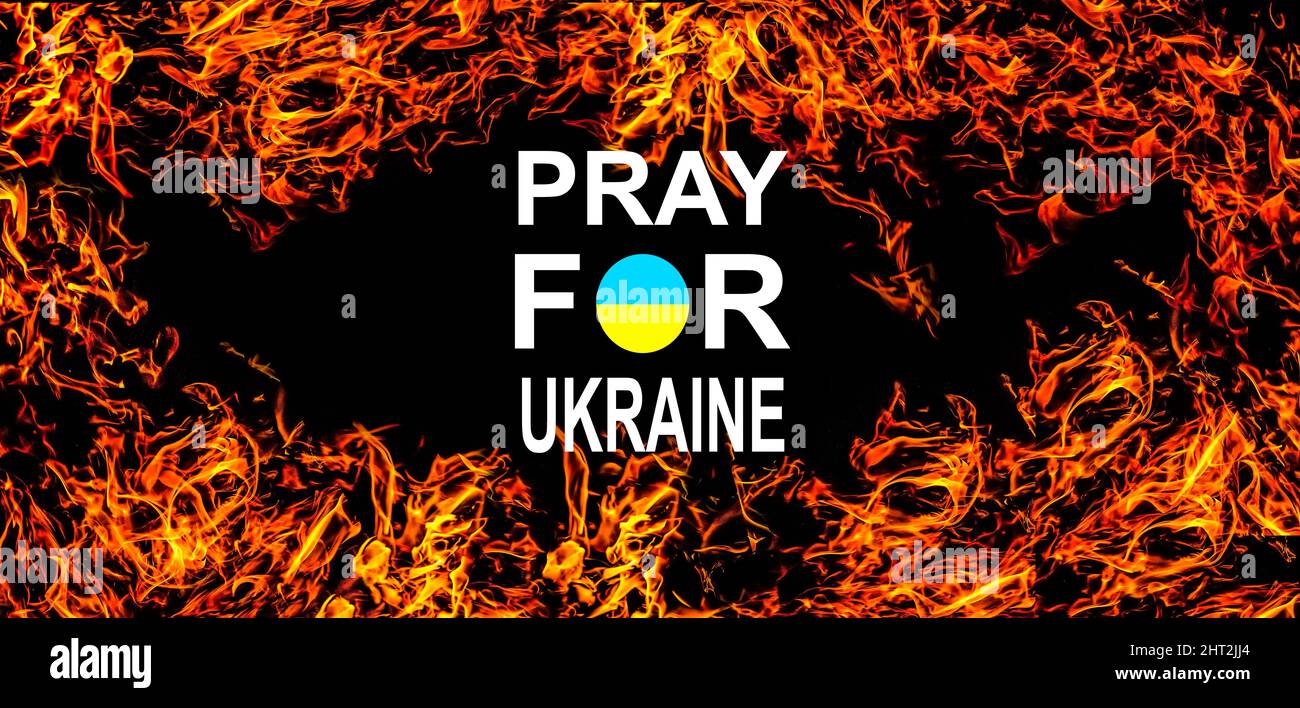 Pray for ukraine. hands pray on ukraine flag Stock Photo - Alamy