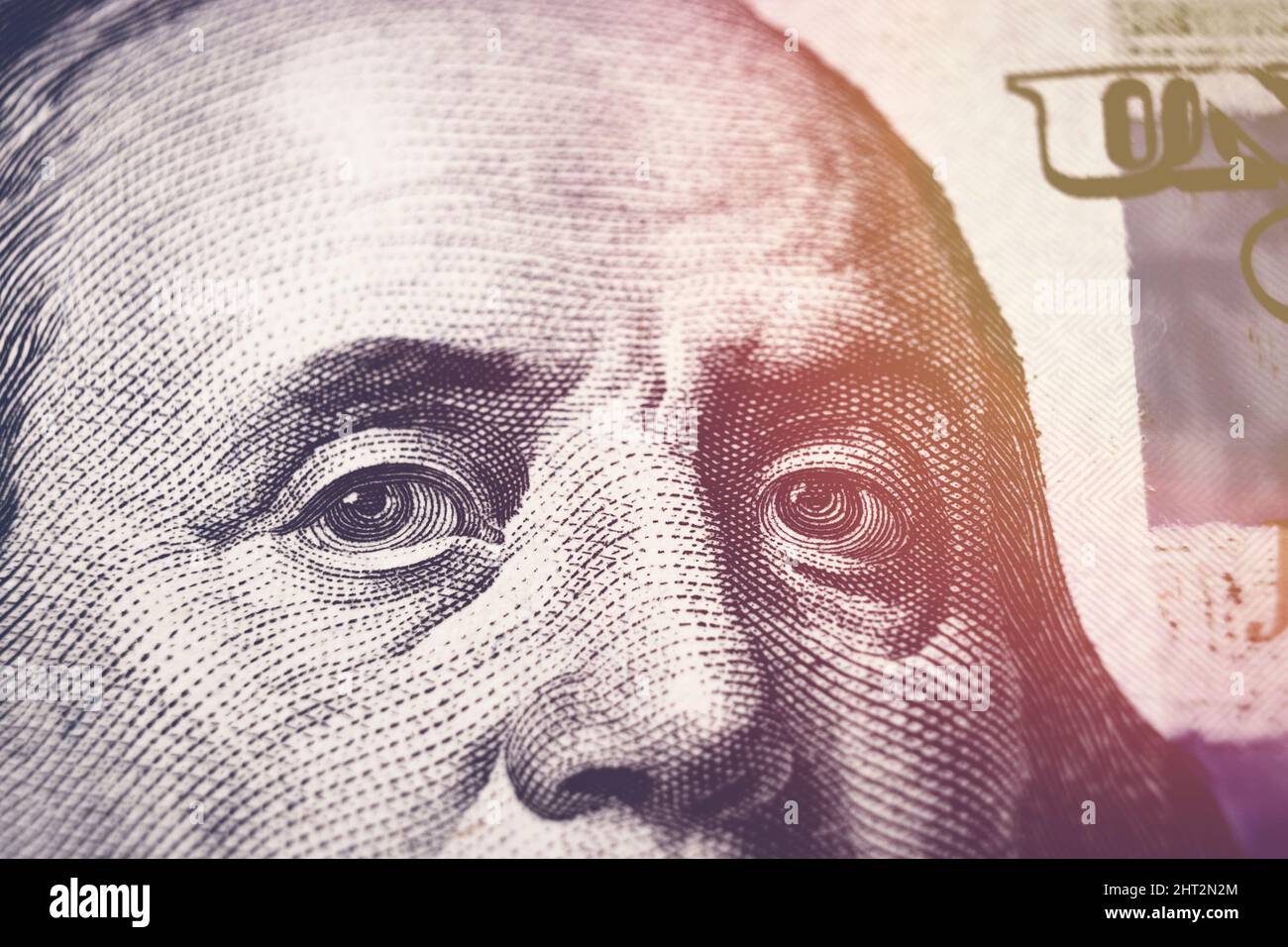 United states hundred dollars money bill, Benjamin Franklin portrait on 100 banknote with sunlight Stock Photo