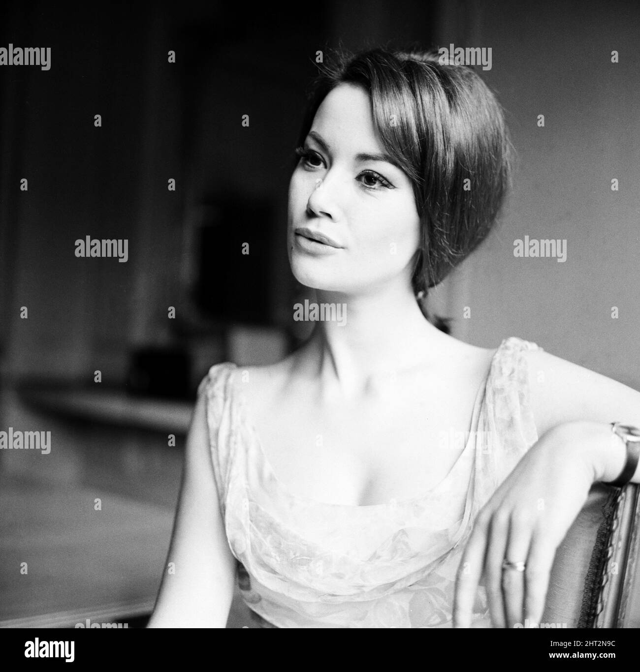Parisienne actress Claudine Auger who will  play Domino in the James Bond film Thunderball,  seen here during an interview with the Daily Mirror show business reporter Donald Zec. 17th February 1965 Stock Photo