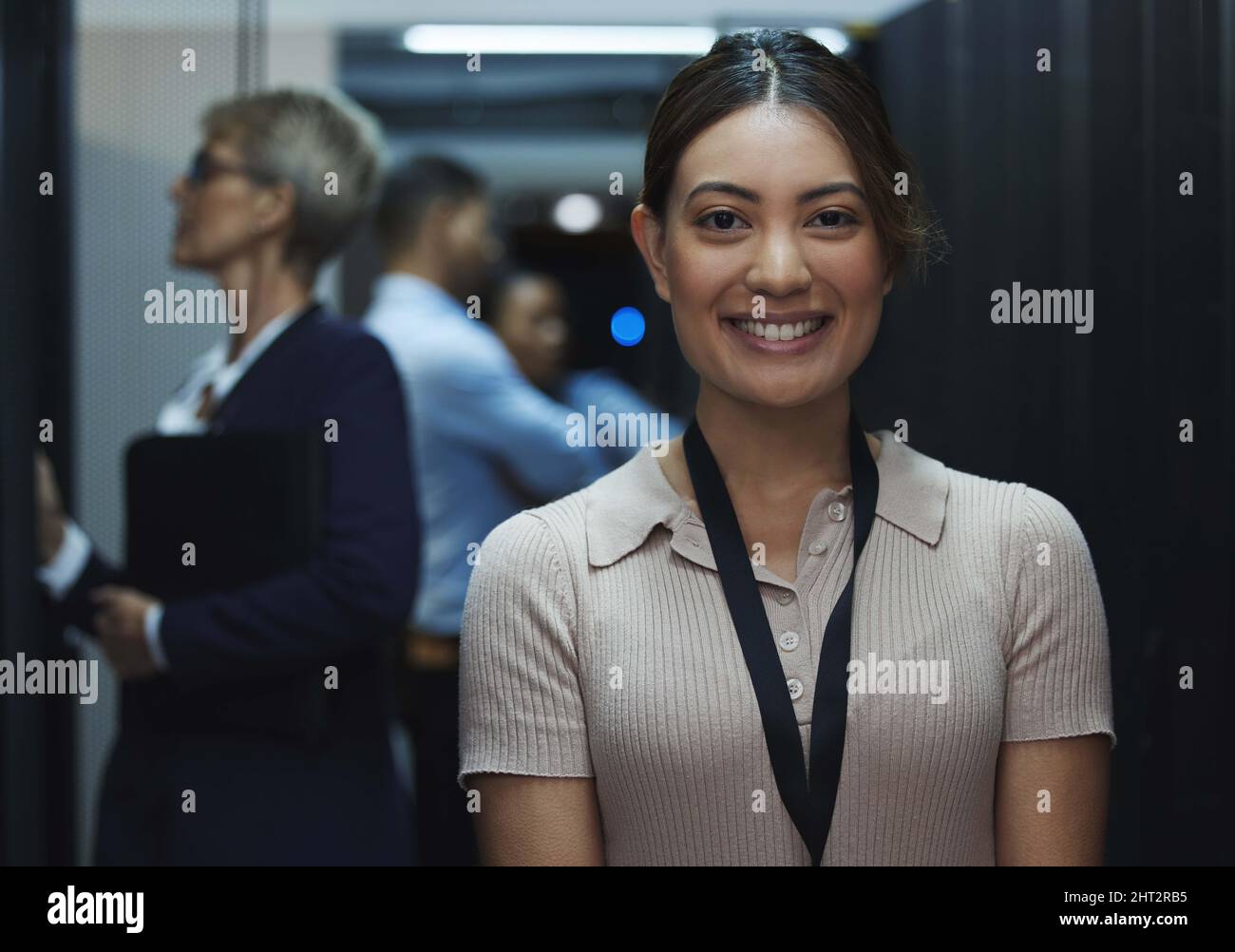 Brimming with excitement for all my tomorrows. Portrait of a young beautiful woman working in server room. Stock Photo