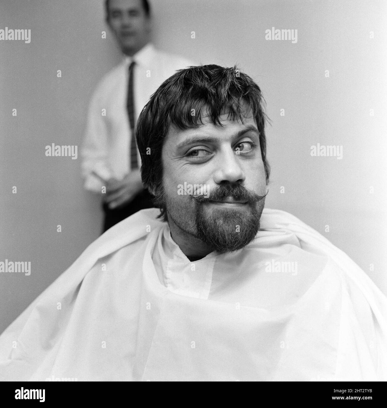 Actor, Oliver Reed, had to make a decision whether to keep his beard or to keep the popularity of his teenage public. He has worn his beard for a long time, in all his TV serials, and in his last film 'The Trap'. The decision arose when three teenage magazine refused to print pictures of him with his beard. Pictured, before his beard was completely shaved off. 15th February 1966. Stock Photo