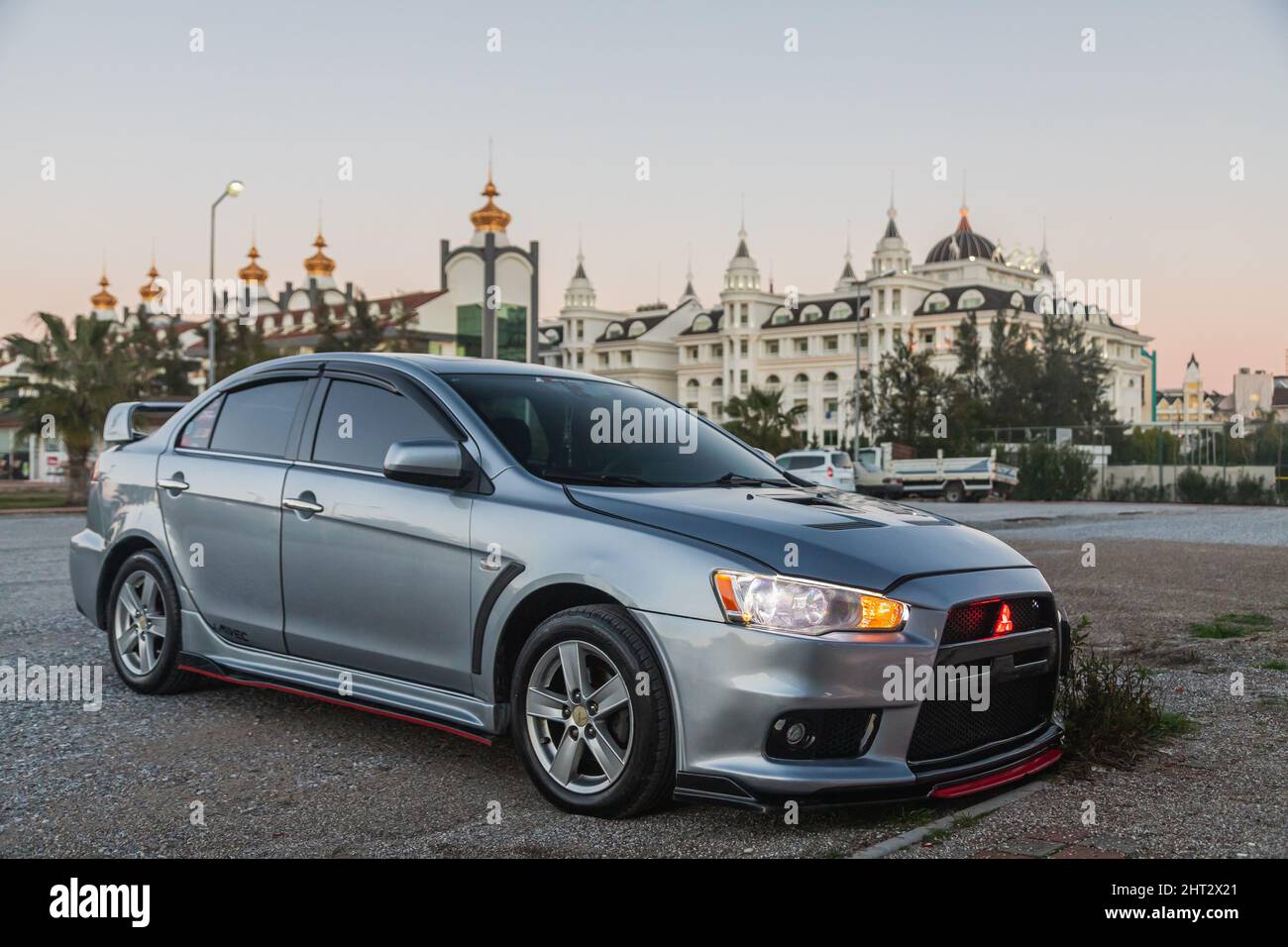 Side, Turkey – February 02 2022:  silver Mitsubishi Lancer    is parked  on the street on a warm  autumn  day against the backdrop of a street, hotel Stock Photo
