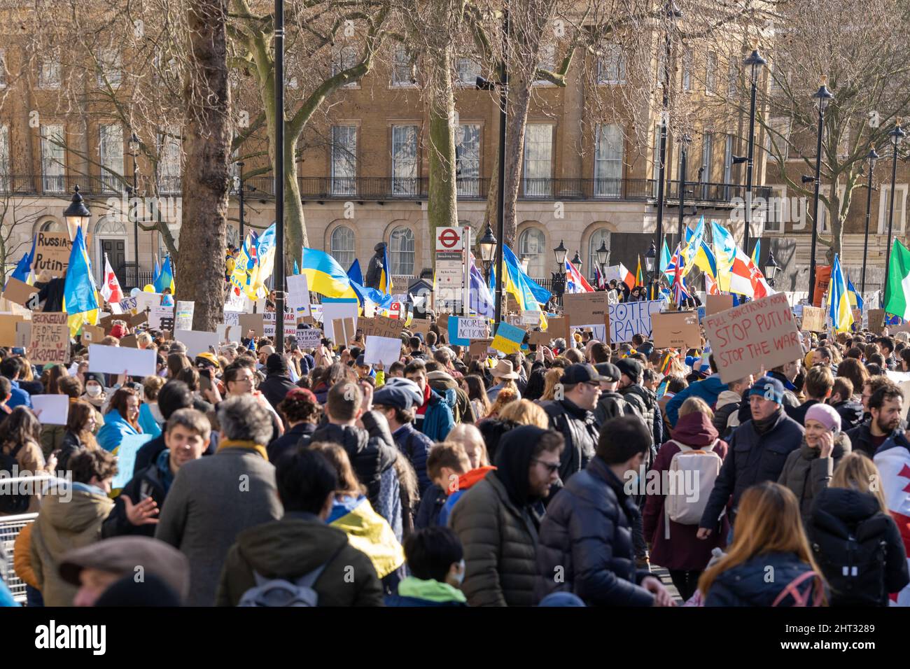 London, UK, 26th Feb, 2022, Anti-war protesters draped in Ukrainian flags were part of hundreds gathered along Whitehall in a rally and demonstration Stock Photo