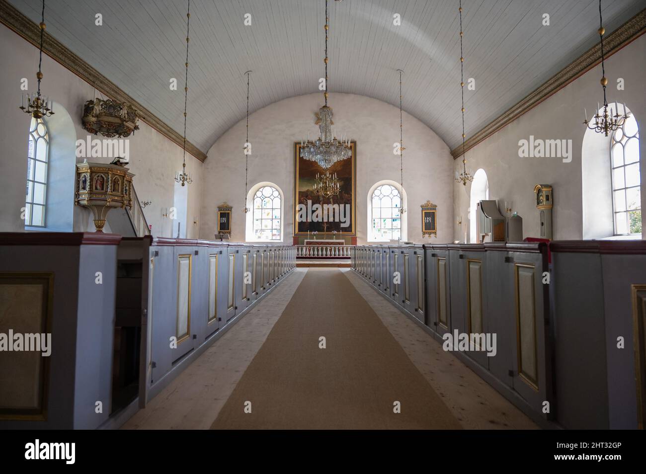 Interior shot of an empty church pathway decorated with holy icons and ...