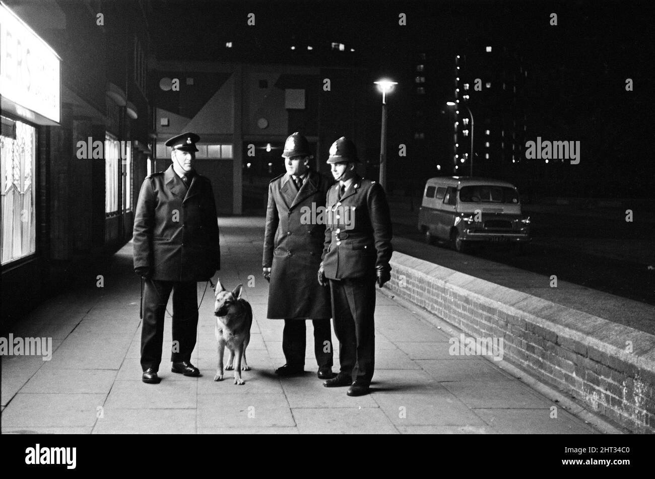 Police and a tracker dog patrol the shopping centre in Kirkby, Liverpool. 18th March 1965. Stock Photo