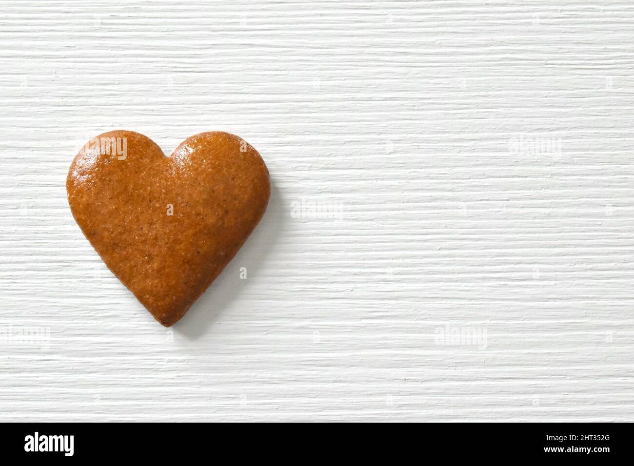 Gingerbread heart on a white background with a wood texture, can be ...