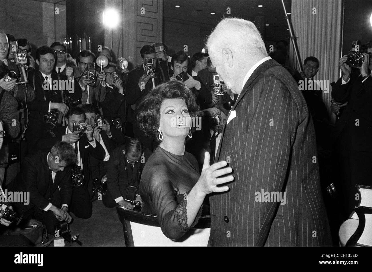 Sophia Loren and Charlie Chaplin at a press conference at the Savoy Hotel, London, where they discussed details of Charlie's first film for nine years. He is directing and Sophia is starring in the film, 'A Countess from Hong Kong'. 1st November 1965. Stock Photo