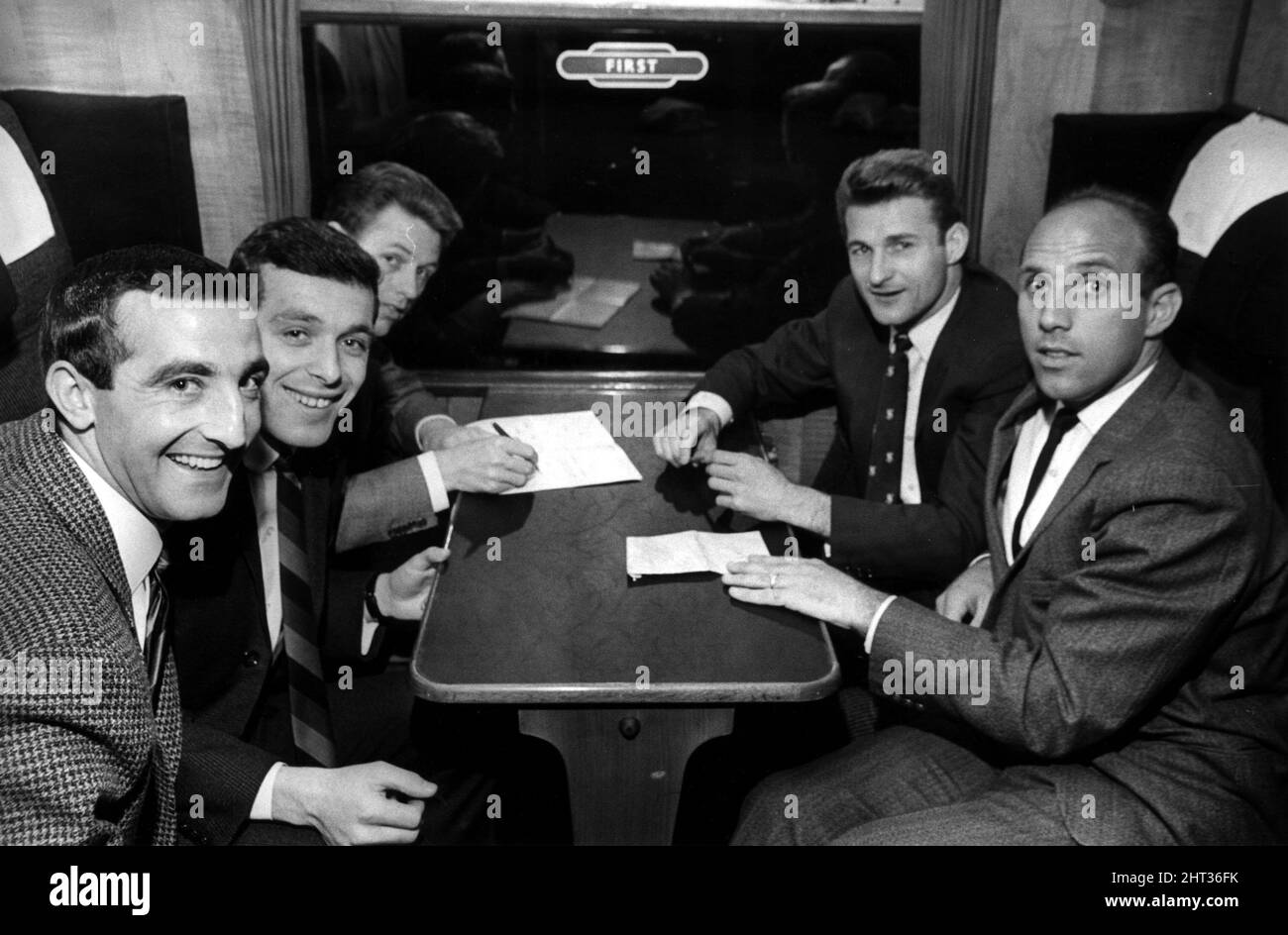 Liverpool football players sitting in first class as they wait for train to depart Liverpool Lime St. Station April 1965. They are heading down to London, to play Leeds United in the FA Cup Final at Wembley (1st May).  Left to Right Gerry Byrne Ian Callaghan Gordon Milne Roger Hunt Ronnie Moran Stock Photo