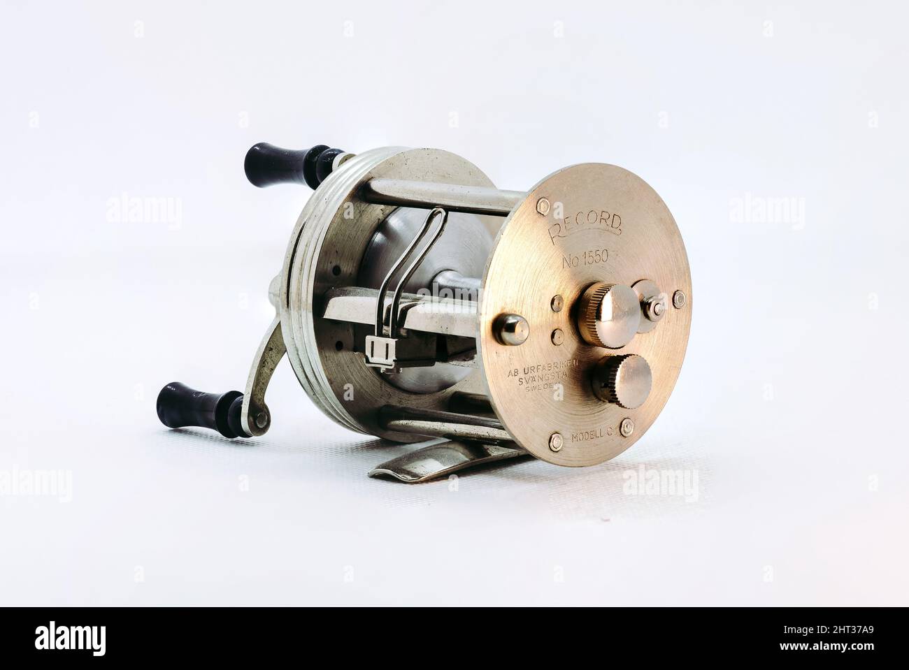 Closeup of a vintage fishing reel on white background Stock Photo - Alamy