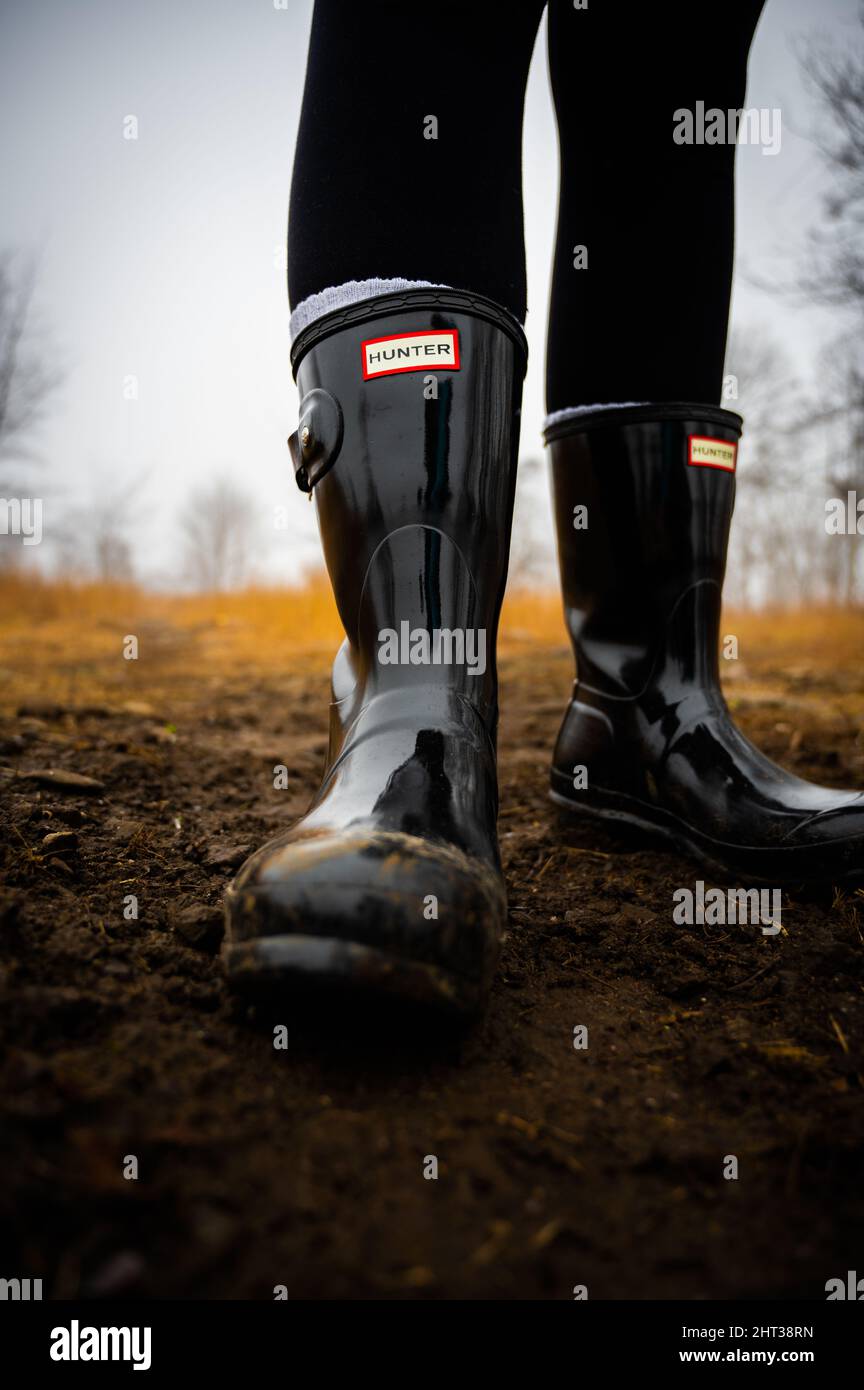 Closuep shot of black of boots in the mud Stock Photo - Alamy