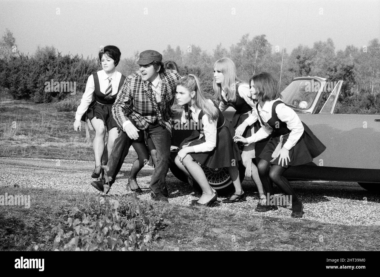 The filming of 'The Great St Trinian's Train Robbery' starring Portland Mason (James Mason's daughter) and George Cole as 'Flash' Harry. On location at Longmoor Army Camp, near Liss, Hampshire. 17th October 1965.The filming of 'The Great St Trinian's Train Robbery' starring Portland Mason (James Mason's daughter) and George Cole as 'Flash' Harry. On location at Longmoor Army Camp, near Liss, Hampshire. 17th October 1965. Stock Photo