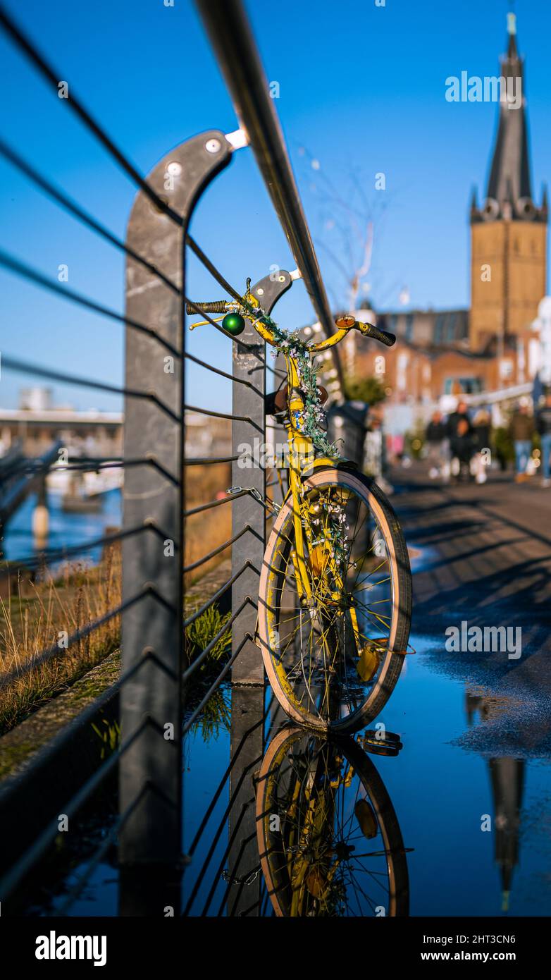 Vertical shot of yellow bicycle parked beside the fence Stock Photo - Alamy