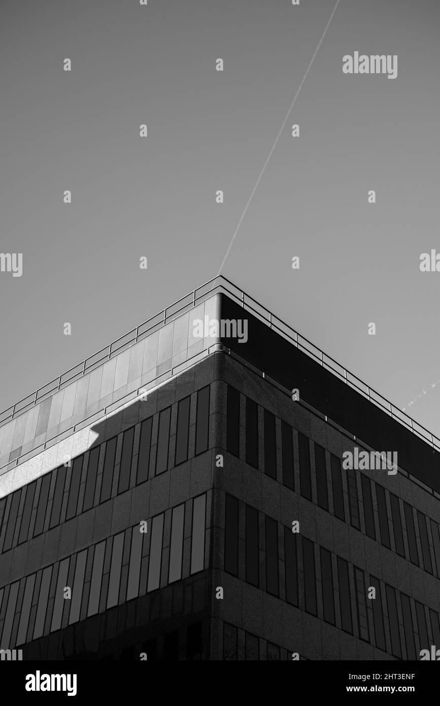 Vertical grayscale shot of modern facade office building Stock Photo ...