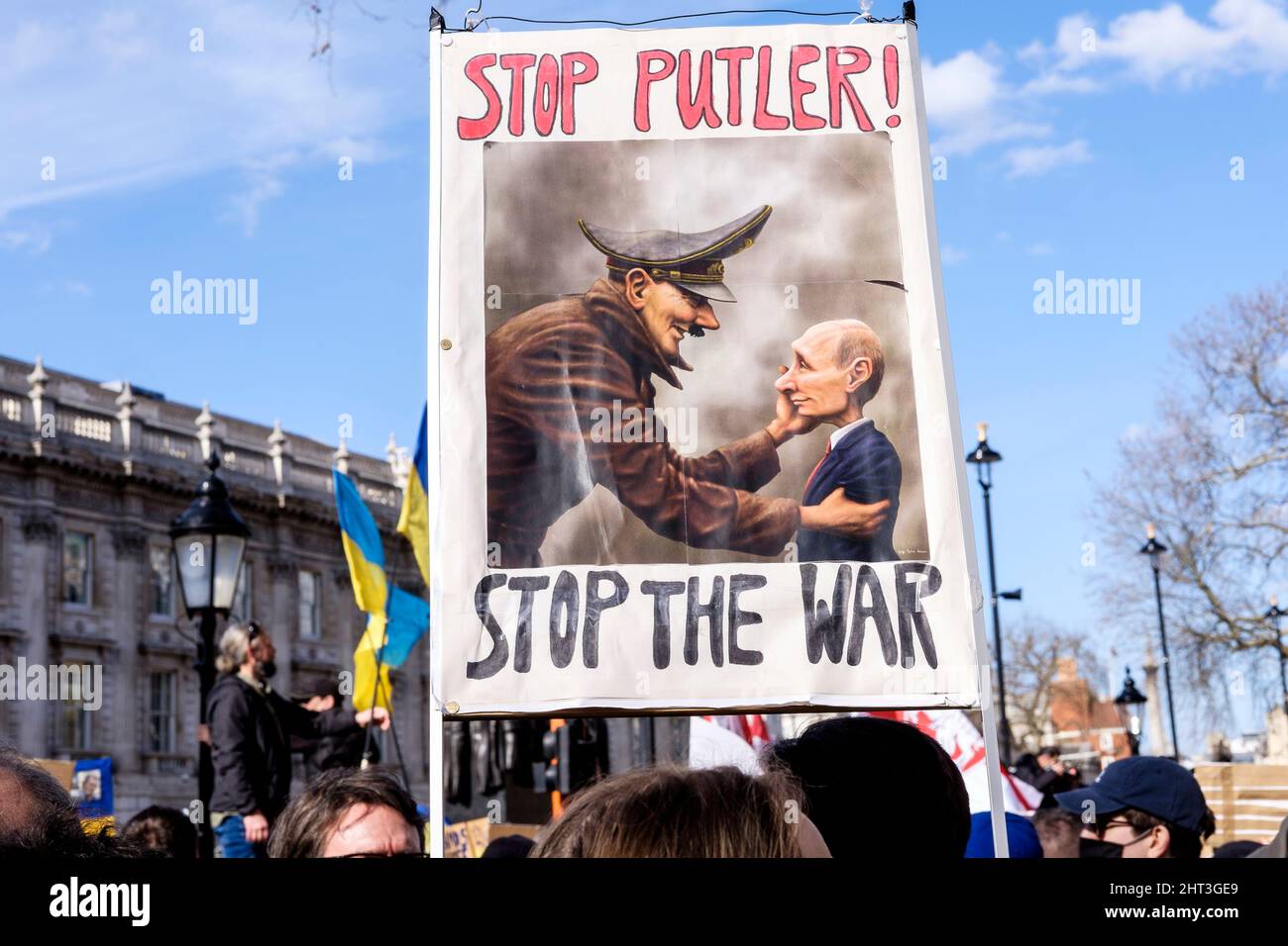 26th February 2022: Ukrainian nationals and pro-Ukraine supporters rally in Whitehall  to protest against the Russian invasion of Ukraine. London, United Kingdom. Pictured: A placard depicting Russian President Putin with Adolph Hitler. Stock Photo
