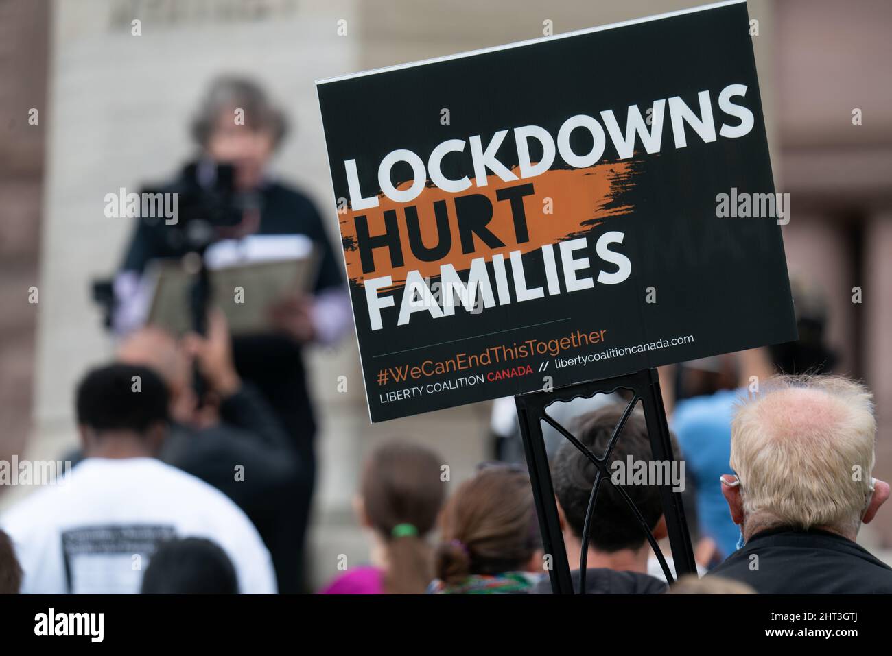 Lockdowns Hurt Families Liberty Coalition Canada anti mask and lockdown sign in Toronto crowd. Stock Photo