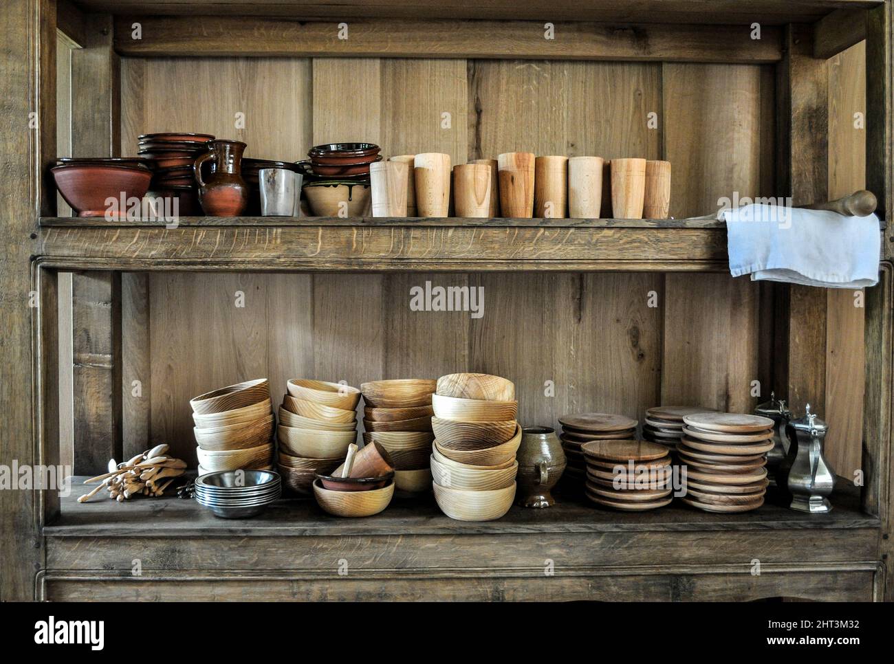 Front view of rustic kitchen shelves with tableware Stock Photo - Alamy
