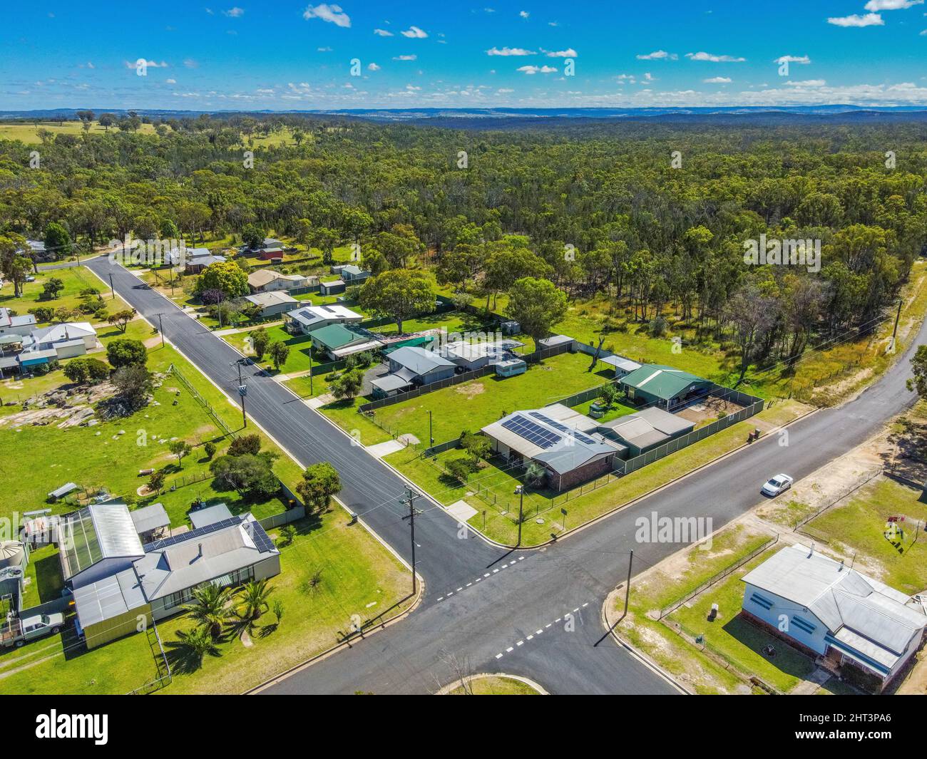 Aerial View of the town of Gilgai surrounded by green rainforests in