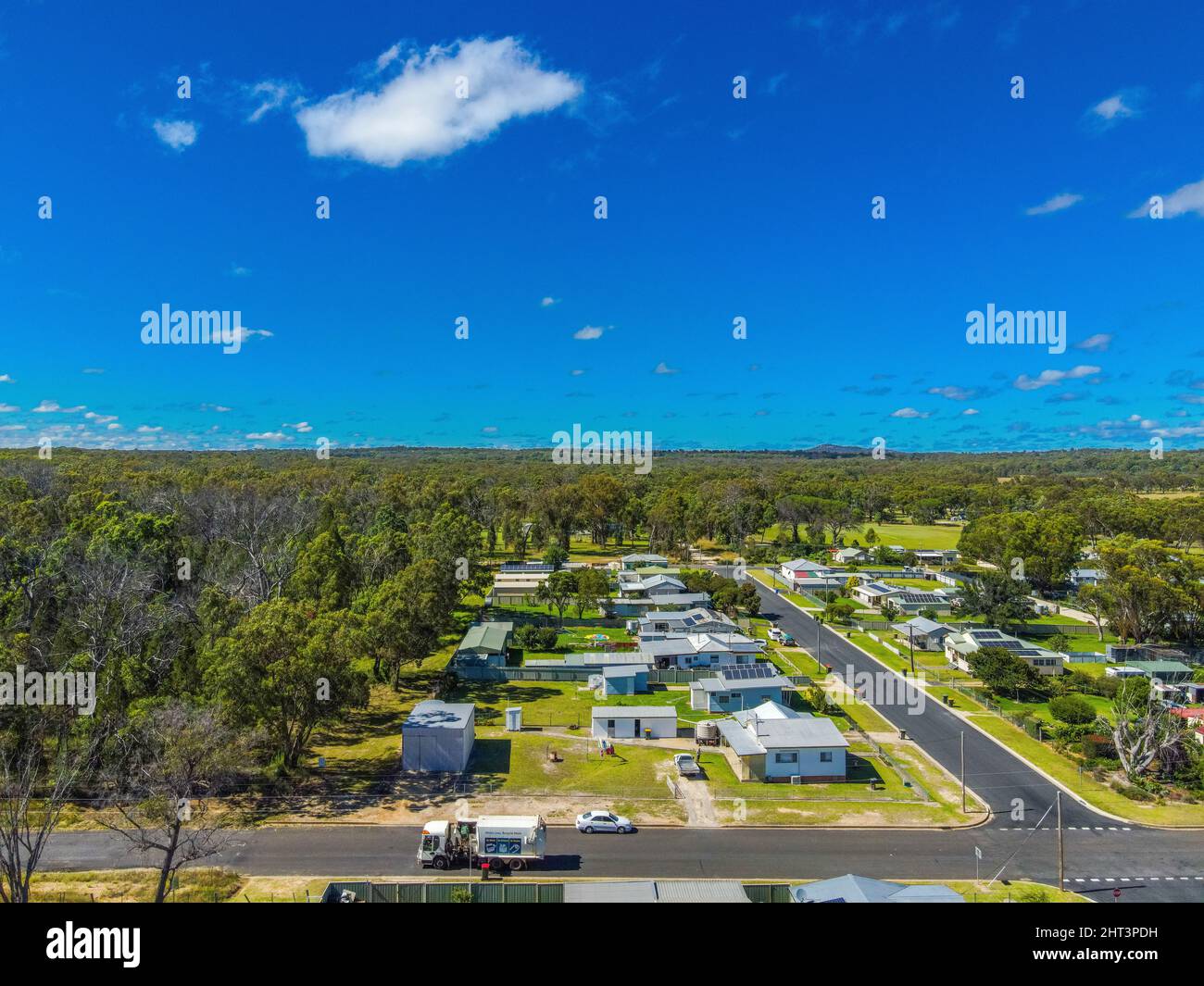 Aerial View of the town of Gilgai surrounded by green rainforests in
