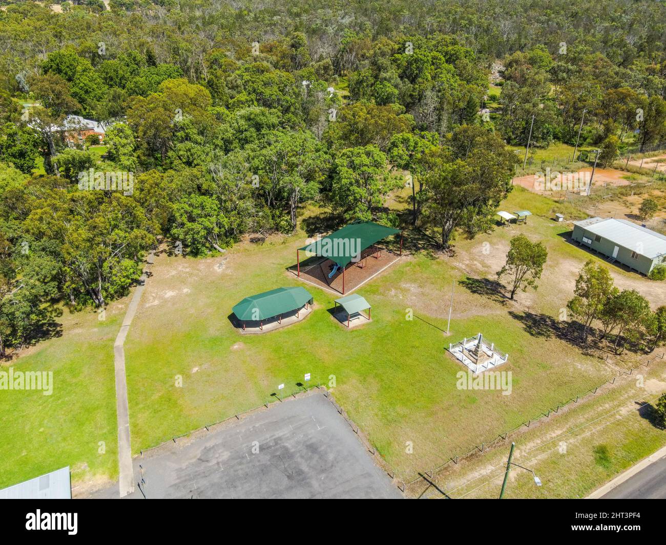 Aerial View of the town of Gilgai surrounded by green rainforests in